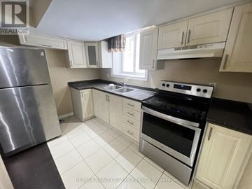 Whitby (Taunton North) house for rent - A kitchen with white cabinets and black countertops.