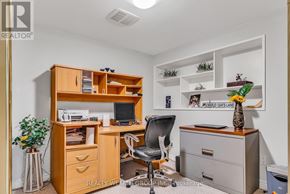 Mississauga (Mississauga Valleys) house for rent - A well-organized office space with a wooden desk, chair, and shelving unit.