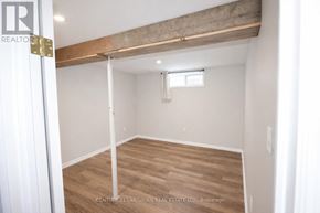Prince Edward County (Picton Ward) duplex for rent - A room with a window and a wooden beam on the ceiling.