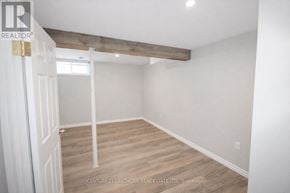 Prince Edward County (Picton Ward) duplex for rent - A room with a wooden beam on the ceiling and white walls.
