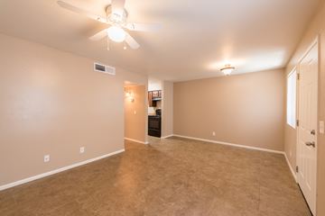 Phoenix apartment for rent - the spacious living room with carpet and a ceiling fan