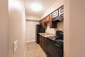 Phoenix apartment for rent - a kitchen with black appliances and a sink and a refrigerator