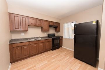 Phoenix apartment for rent - a kitchen with black appliances and wooden cabinets