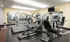 Denver apartment for rent - a gym with cardio equipment and weights on the floor