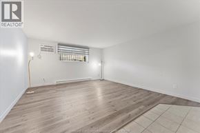 Windsor apartment for rent - A room with wooden flooring and a window with blinds.