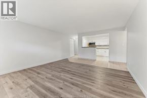 Windsor apartment for rent - A spacious room with wooden flooring and white walls.