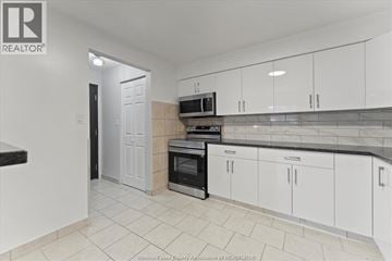 Windsor apartment for rent - A kitchen with white cabinets and a black oven.
