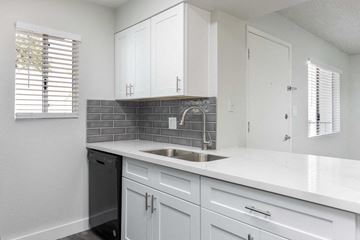 Phoenix apartment for rent - a kitchen with white cabinets and a sink