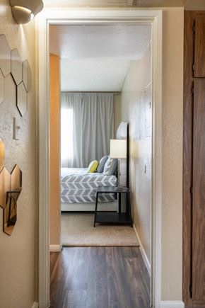 Phoenix apartment for rent - a bedroom with a bed and a lamp and a door to a room