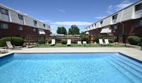 Aurora apartment for rent - a swimming pool with chairs in front of an apartment building