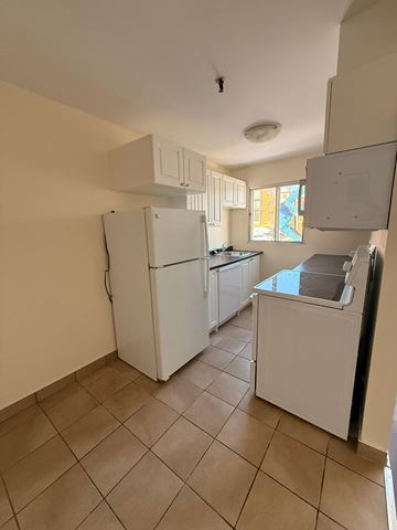 Dartmouth apartment for rent - A kitchen with a white fridge and a white dishwasher.