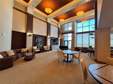 Clearwater Beach apartment for rent - A spacious living room with brown and beige furniture and a large window.
