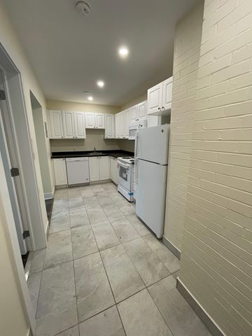 Halifax apartment for rent - A kitchen with white cabinets and a white refrigerator.