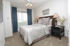Tempe apartment for rent - a bedroom with a large bed and a ceiling fan