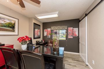 Tempe apartment for rent - a dining room with chairs and a table with flowers