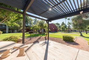 Tempe apartment for rent - a patio with a pergola and a picnic table in front of a yard