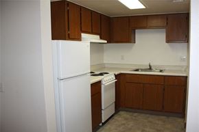 Phoenix apartment for rent - a kitchen with a white refrigerator and a sink