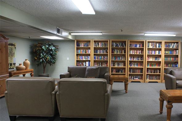 Phoenix apartment for rent - a living room filled with furniture and a book shelf