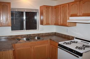 Guadalupe apartment for rent - a kitchen with a stove and a sink and a window