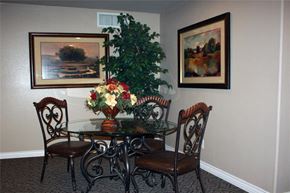 Guadalupe apartment for rent - a dining room table with chairs and a vase of flowers