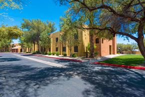 Tucson apartment for rent - a street in front of a building with trees