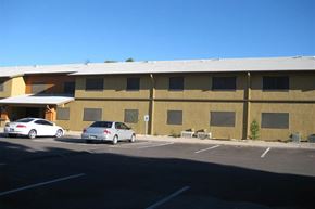 Safford apartment for rent - a large building with cars parked in a parking lot
