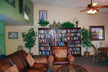Phoenix apartment for rent - a living room with leather furniture and a book shelf