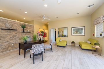 Guadalupe apartment for rent - a living room with yellow furniture and a brick wall
