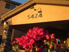 Guadalupe apartment for rent - a bunch of red flowers in front of a building