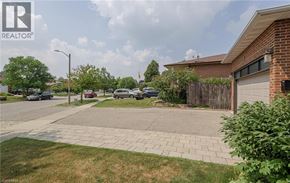Brampton house for rent - A residential area with a house, cars, and a REALTOR® logo.