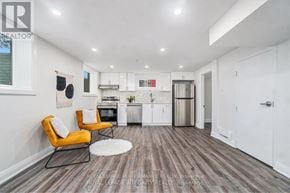 Ottawa house for rent - A modern kitchen with a white wall and a yellow chair.
