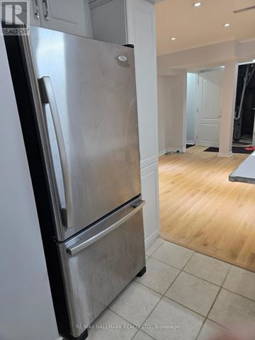 Vaughan (Patterson) house for rent - A stainless steel refrigerator in a kitchen with wooden flooring.