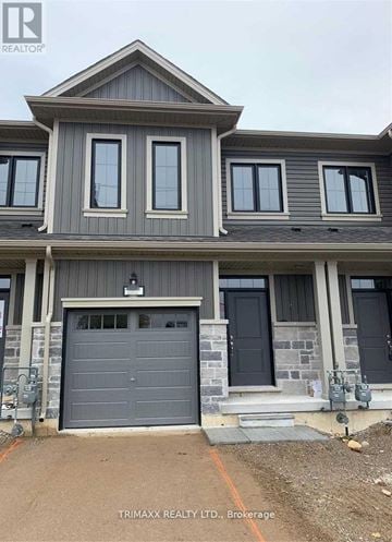 Zorra (Thamesford) townhouse for rent - A house with a grey garage door is for sale.