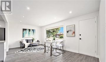 Ottawa house for rent - A living room with a white couch and a zebra print rug.