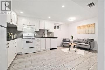 Ottawa house for rent - A modern kitchen with white cabinets and a grey sofa.