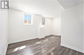 Ottawa house for rent - A white room with wooden flooring and a window.