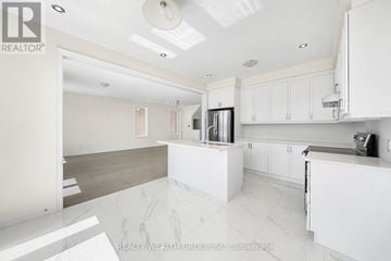 East Gwillimbury (Queensville) house for rent - A modern kitchen with white cabinets and a marble floor.