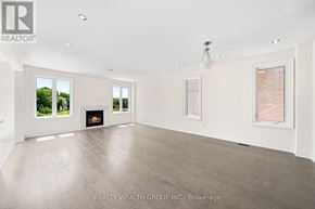 East Gwillimbury (Queensville) house for rent - A spacious room with a fireplace and large windows.