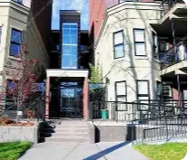 Edmonton apartment for rent - A building with a black gate and a white door.