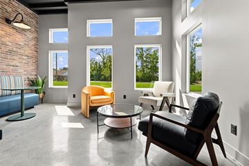Jeffersonville apartment for rent - A living room with a black leather chair and a glass table.