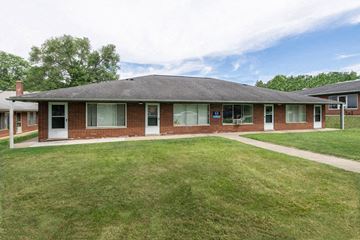 Ann Arbor apartment for rent - the front of a brick house with a grassy yard