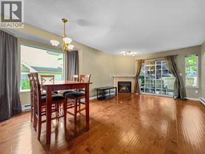 Burnaby townhouse for rent - A dining room with a wooden table and chairs.