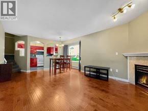 Burnaby townhouse for rent - A living room with a fireplace and a dining table.
