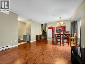 Burnaby townhouse for rent - A living room with a wooden floor and a dining table with chairs.