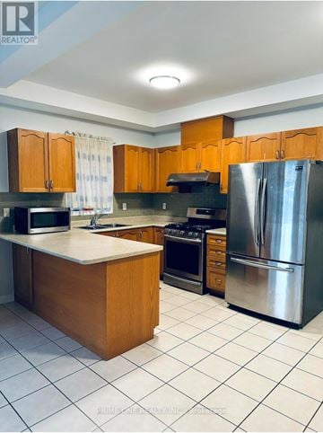 Markham (Cedarwood) house for rent - A kitchen with wooden cabinets and a stainless steel refrigerator.