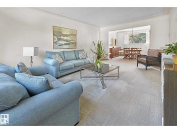 Edmonton house for rent - A living room with a blue couch and a glass coffee table.