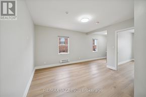 Oshawa (Central) multi-family for rent - A room with a window and a door is for sale.