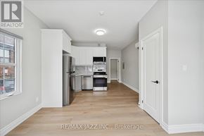 Oshawa (Central) multi-family for rent - A kitchen with white cabinets and a refrigerator.