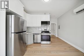 Oshawa (Central) multi-family for rent - A modern kitchen with white cabinets and stainless steel appliances.