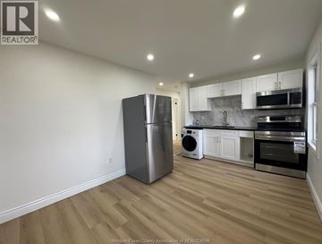 Windsor apartment for rent - A kitchen with a refrigerator, microwave, oven, and dishwasher.